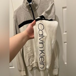 Gray and white Calvin Klein zip up jacket. Men’s medium, women’s L/XL.